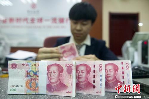 11月5日，人民幣中間價(jià)漲勢(shì)延續(xù)。中國外匯交易中心報(bào)人民幣對(duì)美元匯率中間價(jià)為6.8976，較前一交易日大幅上調(diào)395個(gè)基點(diǎn)，重新返回6.8區(qū)間，創(chuàng)下近一個(gè)月以來的最高值。圖為11月1日，山西太原一銀行工作人員正在清點(diǎn)貨幣。<a target='_blank'  data-cke-saved- ><p  align=