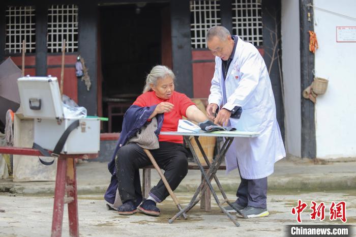 資料圖，貴州村醫(yī)給村民看病?！■暮陚?攝